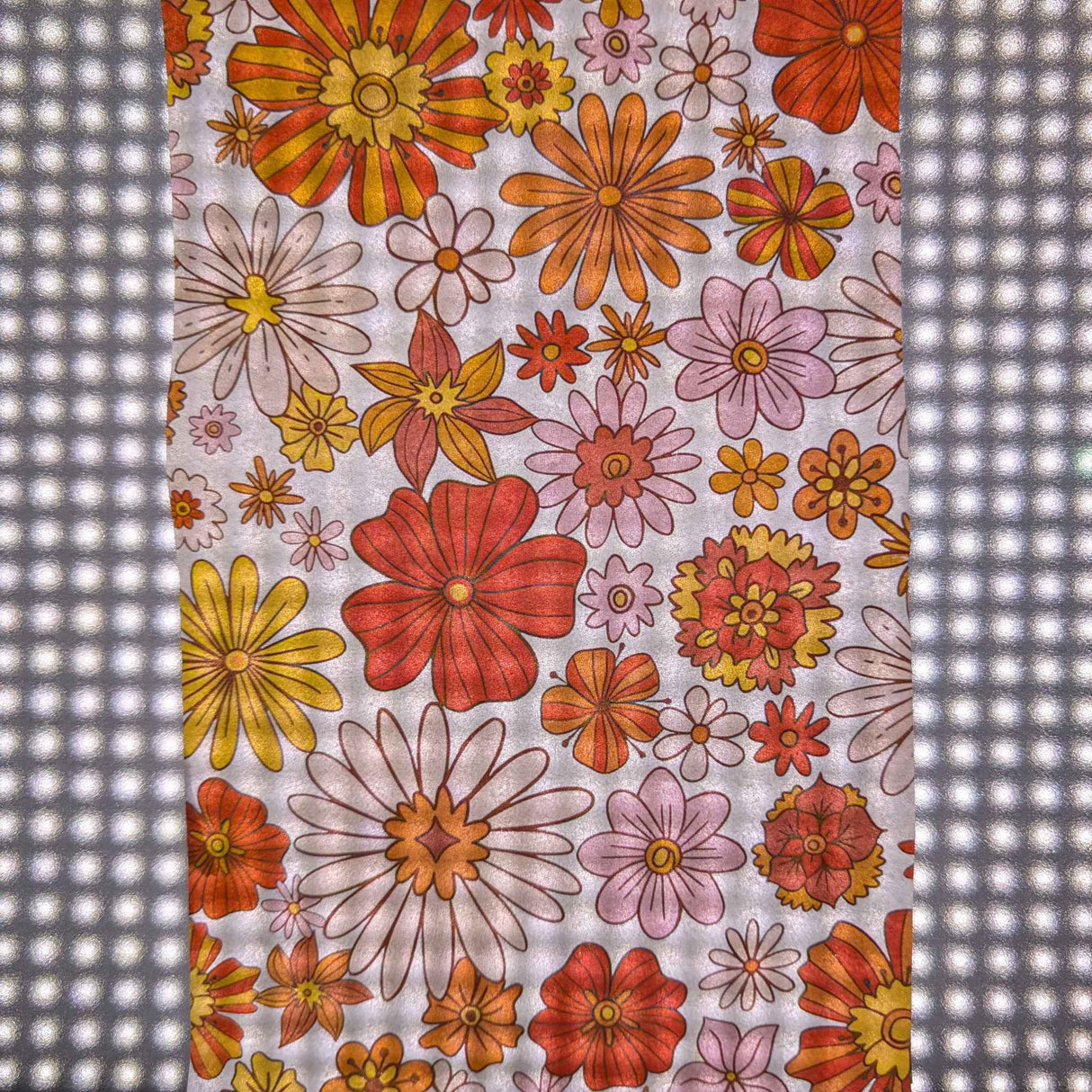 Floral patterned print on wet strength using a laser printer displayed over a studio light.
