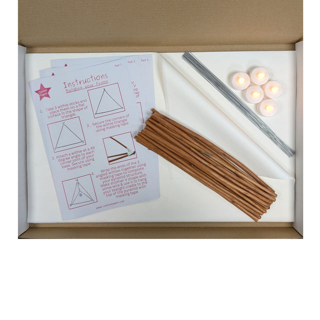 Willow lantern-making kit contents with white tissue paper, precut willow, florist wire, five LED tealights and instructions