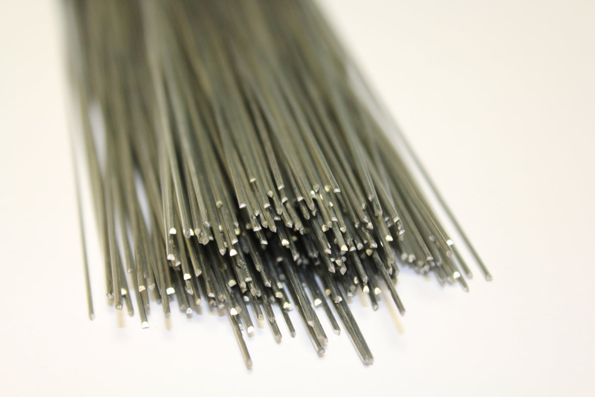 A bundle of thin dark gray metallic rods or wires clustered together on a plain white background.