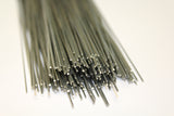 A bundle of thin dark gray metallic rods or wires clustered together on a plain white background.